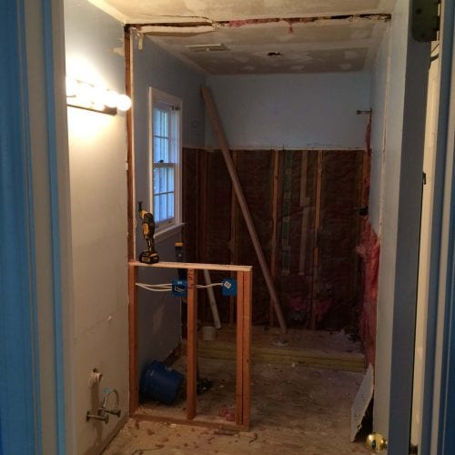 Modern bathroom renovation under construction, featuring drywall installation and electrical wiring, showcasing professional contracting services for home remodeling projects.