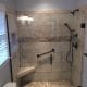 Shower remodel with tiled walls and walk-in accessibility features for senior-friendly bathroom installation.