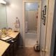 Bright bathroom with shower and bathtub, modern fixtures, and a spacious vanity area, showcasing quality home renovation and bathroom remodeling services by My Contracting Guy.
