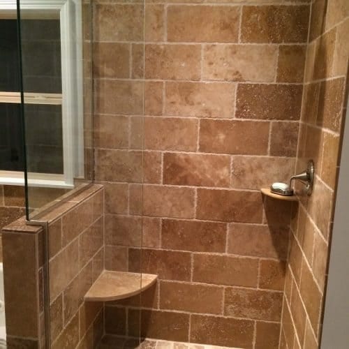 - Modern walk-in shower with natural stone tiles and glass enclosure for a luxurious bathroom upgrade.