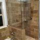 Modern walk-in shower with glass enclosure and stone tile design, perfect for bathroom remodeling by My Contracting Guy. Expert bathroom renovation services in the local area.