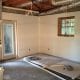 Newly renovated interior room during home construction, showing drywall work, electrical wiring, and window installation. Expert residential contracting services for remodeling and renovation projects.