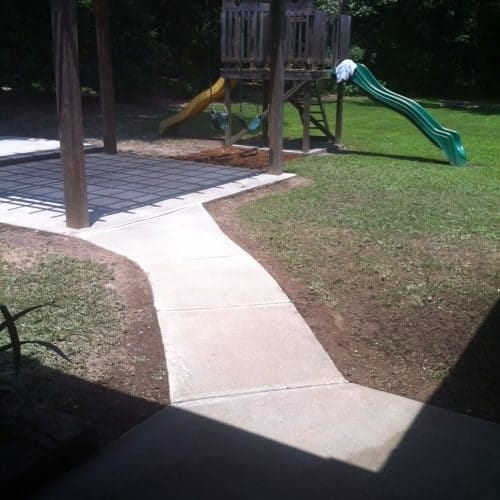 Newly constructed backyard wooden playset with slides and swings, safe outdoor playground building, professional backyard play area installation, My Contracting Guy expert outdoor playset installation, relevance to contracting and outdoor construction services.