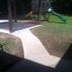 Newly constructed backyard wooden playset with slides and swings, safe outdoor playground building, professional backyard play area installation, My Contracting Guy expert outdoor playset installation, relevance to contracting and outdoor construction services.